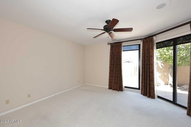 carpeted empty room featuring ceiling fan