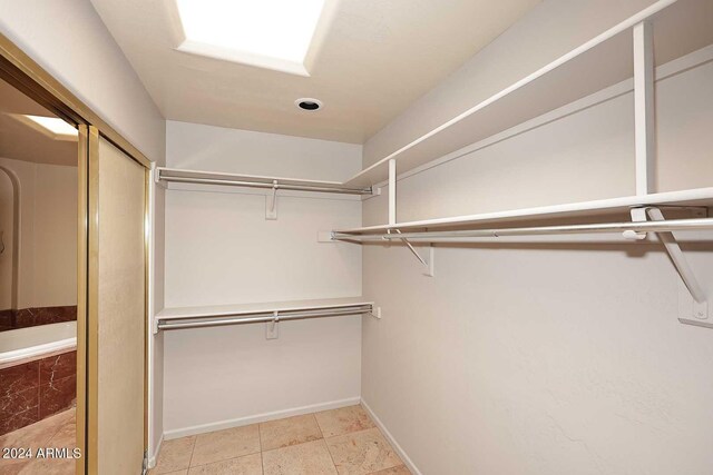 spacious closet with light tile patterned flooring