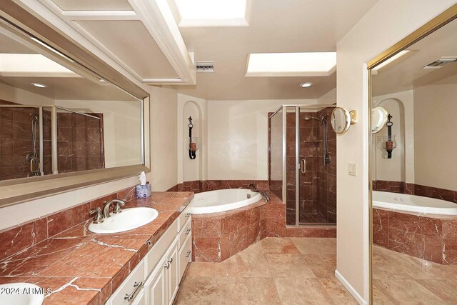 bathroom featuring plus walk in shower and vanity