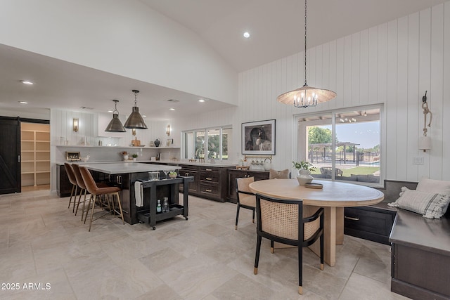 2724 W Colt Rd, Chandler, AZ 85224 - dining space featuring a barn door, high vaulted ceiling, a chandelier, and recessed lighting