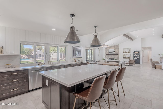 2724 W Colt Rd, Chandler, AZ 85224 - kitchen with dishwasher, a kitchen island, open floor plan, arched walkways, and a kitchen breakfast bar