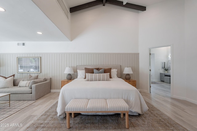 2724 W Colt Rd, Chandler, AZ 85224 - bedroom with light wood-style floors, beamed ceiling, a wainscoted wall, high vaulted ceiling, and ensuite bath