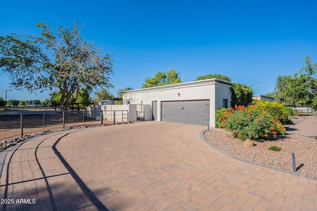 2724 W Colt Rd, Chandler, AZ 85224 - view of side of property with a garage, stucco siding, and decorative driveway