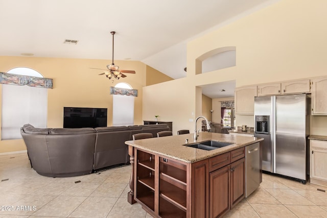 251 E Arabian Dr, Gilbert, AZ 85296 - kitchen with stainless steel appliances, a sink, light tile patterned flooring, ceiling fan, and a center island with sink