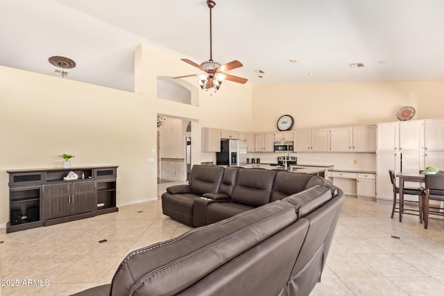 251 E Arabian Dr, Gilbert, AZ 85296 - living area featuring light tile patterned floors, a ceiling fan, high vaulted ceiling, and baseboards