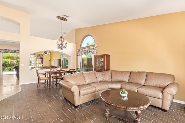 251 E Arabian Dr, Gilbert, AZ 85296 - living area with arched walkways, wood finish floors, baseboards, and high vaulted ceiling