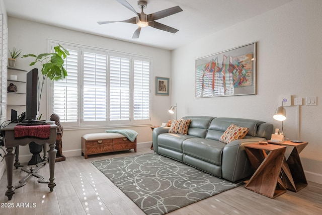 living room featuring ceiling fan and hardwood / wood-style floors