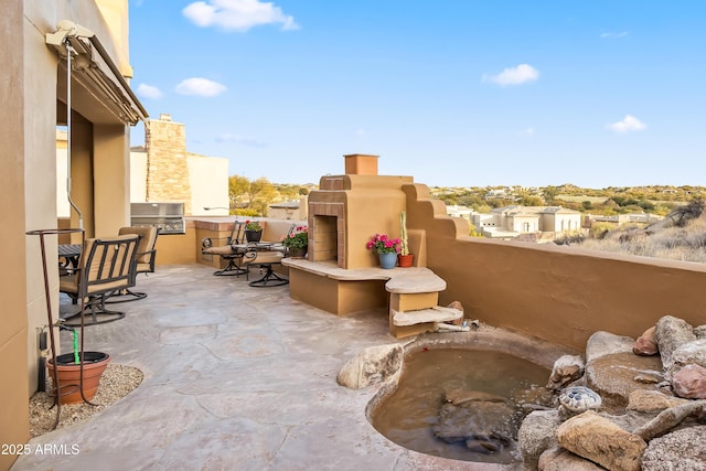 view of patio / terrace featuring exterior kitchen and a grill