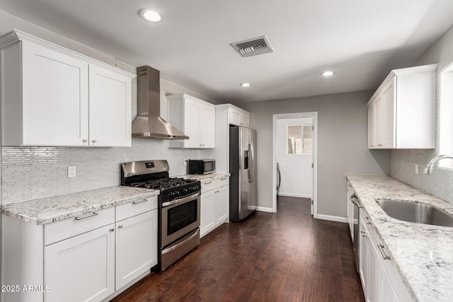 6820 E Pinchot Ave, Scottsdale, AZ 85251 - kitchen with stainless steel appliances, wall chimney range hood, tasteful backsplash, white cabinetry, and recessed lighting