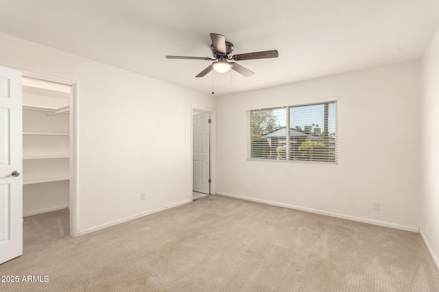 6820 E Pinchot Ave, Scottsdale, AZ 85251 - unfurnished bedroom featuring light colored carpet, a walk in closet, a closet, and ceiling fan