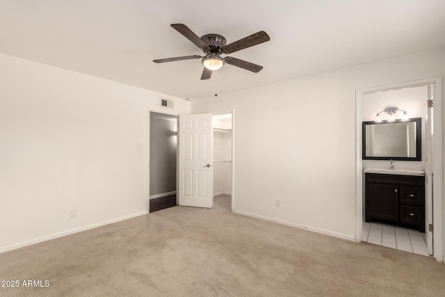 6820 E Pinchot Ave, Scottsdale, AZ 85251 - unfurnished bedroom with light carpet, a spacious closet, ensuite bathroom, a closet, and ceiling fan