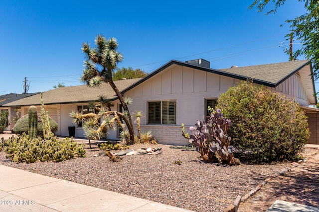 6820 E Pinchot Ave, Scottsdale, AZ 85251 - ranch-style house with board and batten siding and a shingled roof
