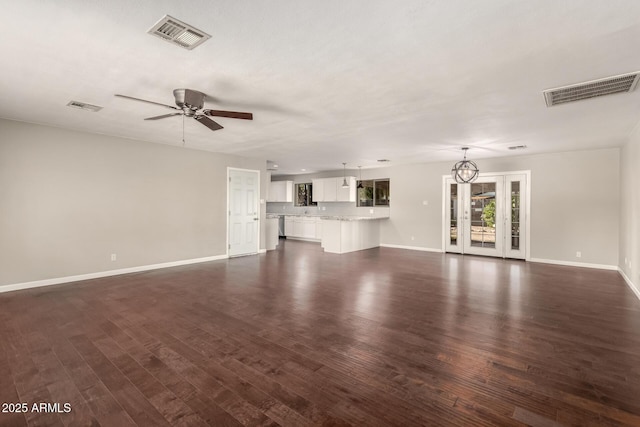 6820 E Pinchot Ave, Scottsdale, AZ 85251 - unfurnished living room with dark wood-type flooring, ceiling fan, and a chandelier