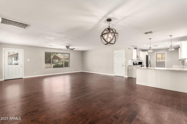 6820 E Pinchot Ave, Scottsdale, AZ 85251 - unfurnished living room with dark wood-type flooring and a ceiling fan