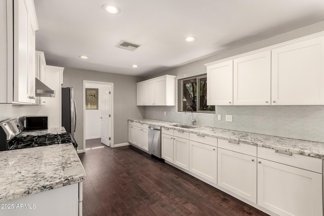 6820 E Pinchot Ave, Scottsdale, AZ 85251 - kitchen featuring range hood, appliances with stainless steel finishes, decorative backsplash, white cabinets, and dark wood-style flooring