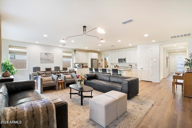 6954 W Maya Way, Peoria, AZ 85383 - living area with light wood-style flooring and recessed lighting