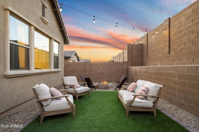 6954 W Maya Way, Peoria, AZ 85383 - yard at dusk with a fenced backyard and an outdoor fire pit