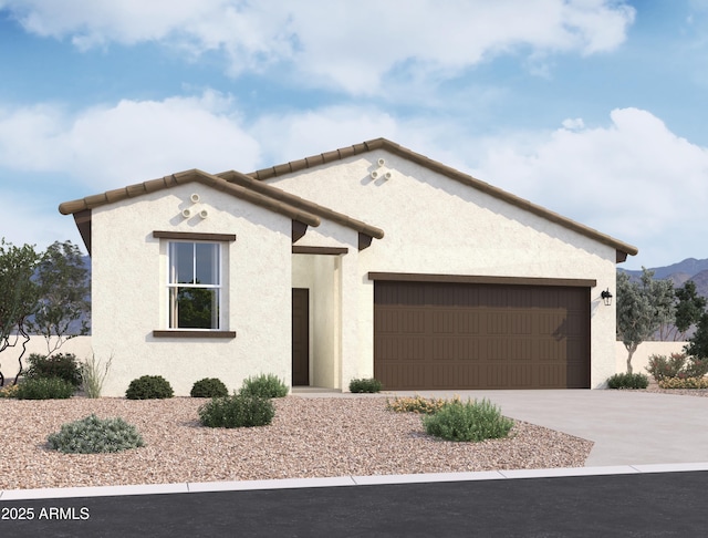 view of front of house with a garage, a tiled roof, concrete driveway, and stucco siding