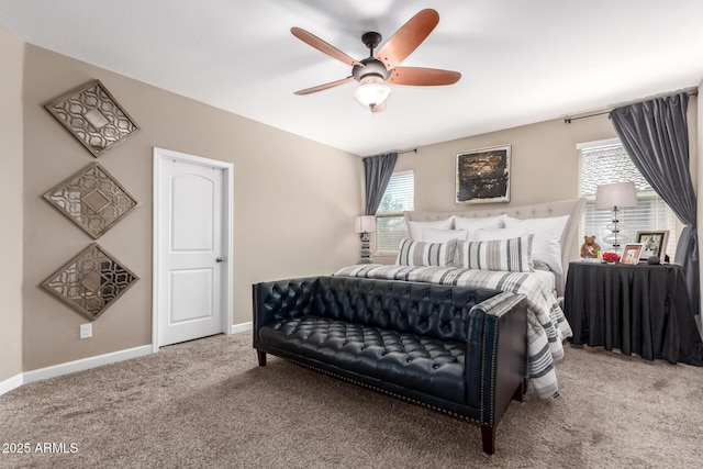 carpeted bedroom featuring baseboards and a ceiling fan
