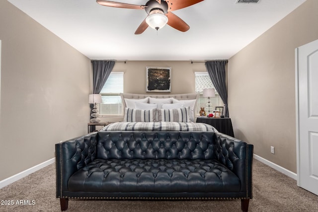 carpeted bedroom with visible vents, baseboards, and ceiling fan
