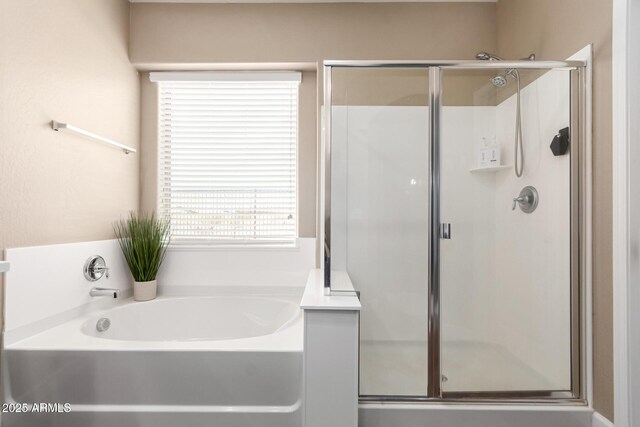bathroom with a shower stall and a garden tub