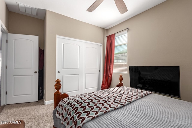 bedroom with visible vents, a ceiling fan, carpet flooring, and a closet