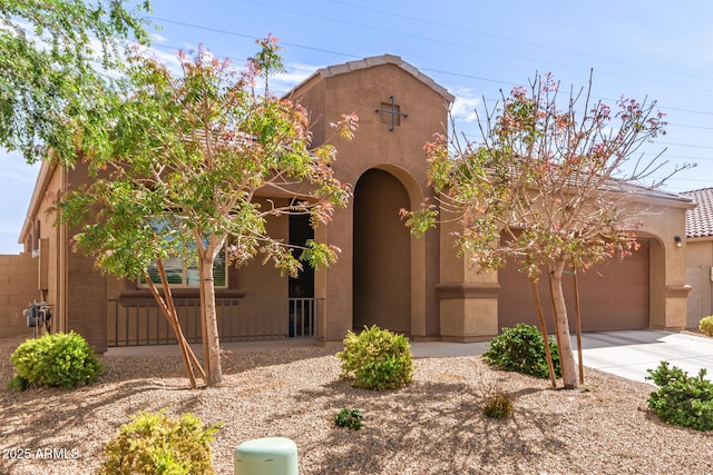 view of front of property with concrete driveway, an attached garage, and stucco siding