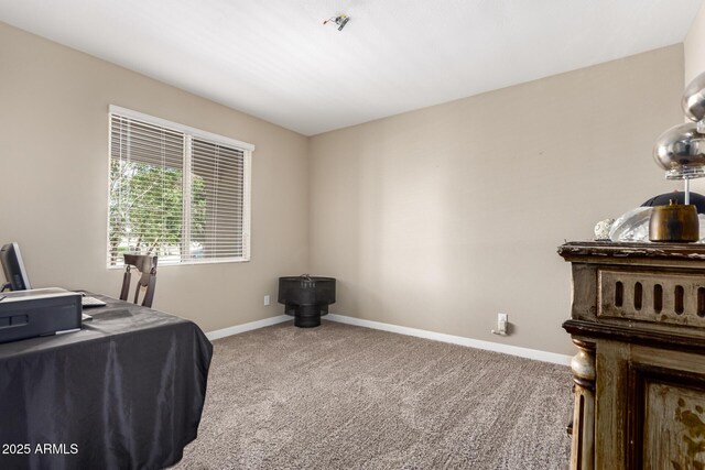 carpeted office featuring baseboards