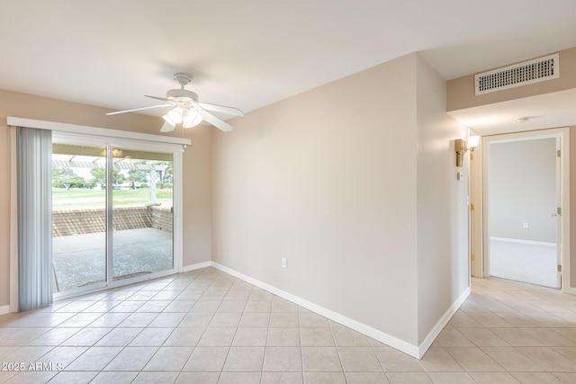 spare room featuring visible vents, ceiling fan, baseboards, and light tile patterned floors