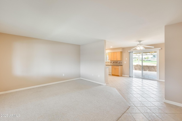 unfurnished living room with ceiling fan, baseboards, and light tile patterned floors