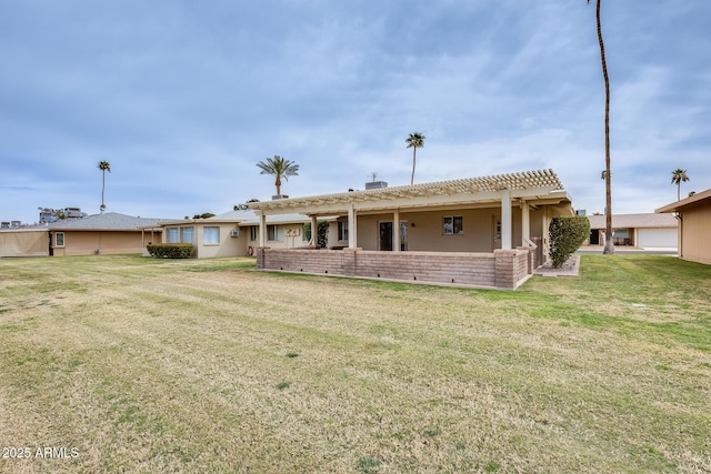 rear view of property featuring a yard and a pergola