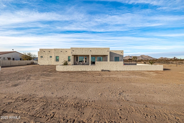 back of property with a mountain view