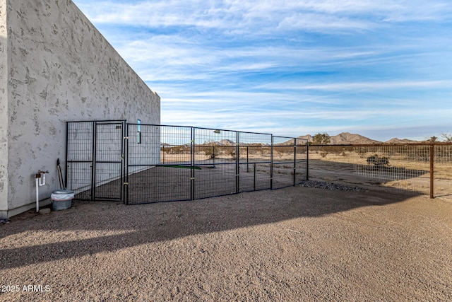 view of gate featuring a mountain view