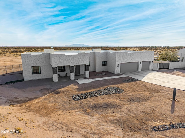 pueblo revival-style home with a garage