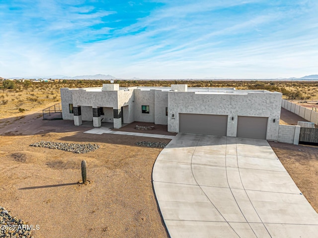 southwest-style home featuring a garage and a mountain view