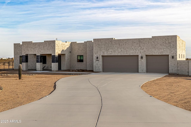 pueblo-style home with a garage