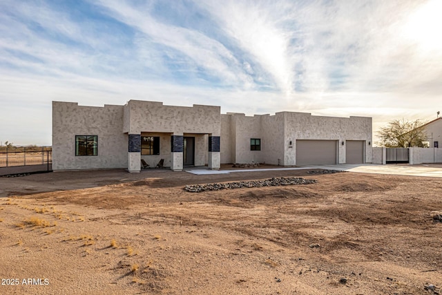 pueblo-style home with a garage