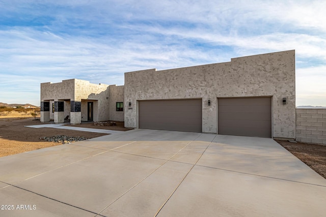 pueblo-style home with a garage