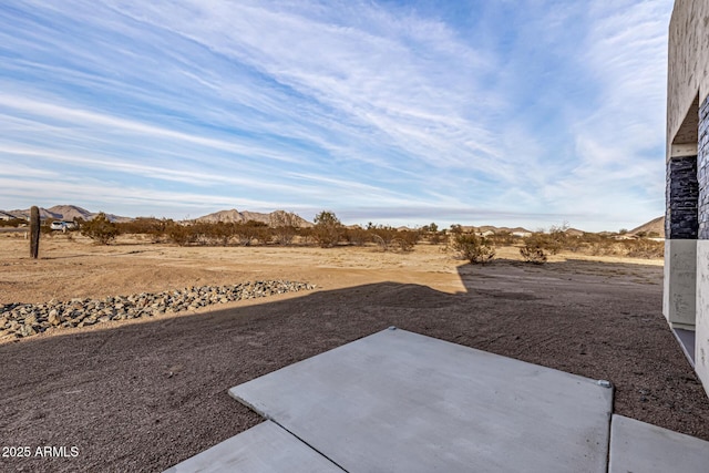 view of yard with a patio and a mountain view