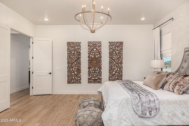 bedroom featuring a chandelier and light hardwood / wood-style floors