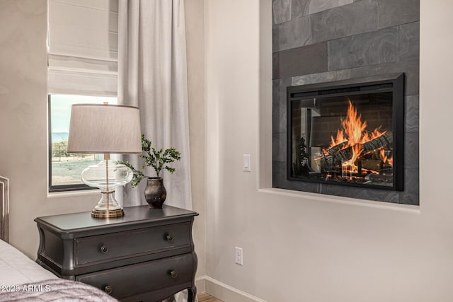 interior details featuring a tile fireplace