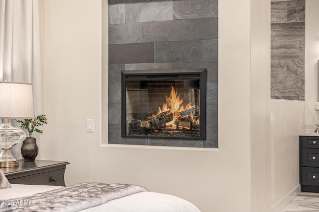 bedroom featuring a tile fireplace