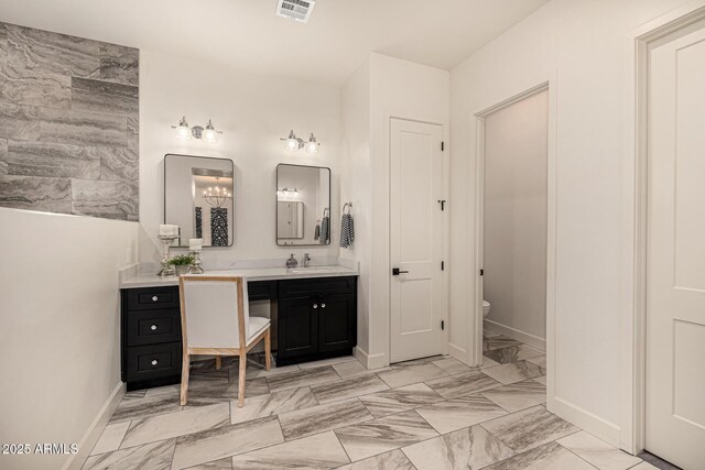 bathroom with vanity and toilet