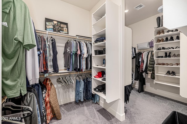 walk in closet with carpet flooring