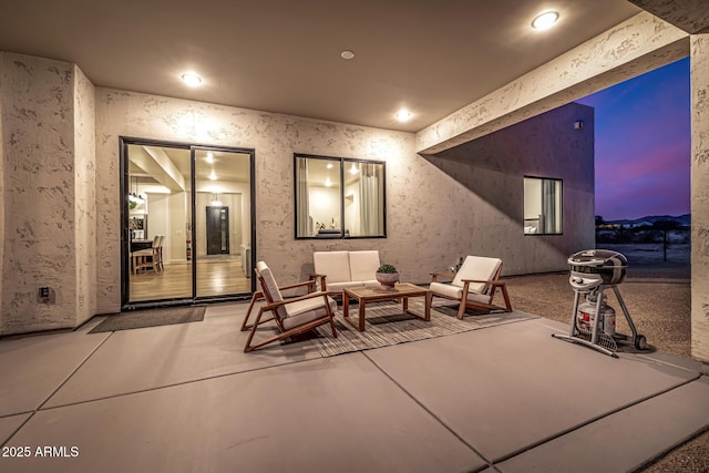 patio terrace at dusk with an outdoor living space