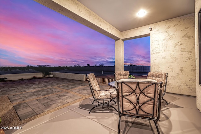 view of patio terrace at dusk