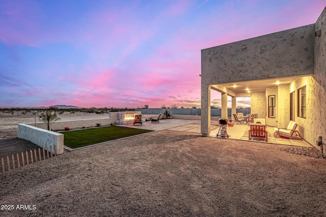 yard at dusk with a patio