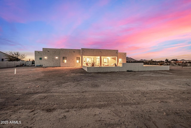 view of back house at dusk