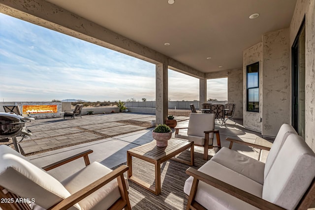 view of patio featuring an outdoor living space with a fire pit