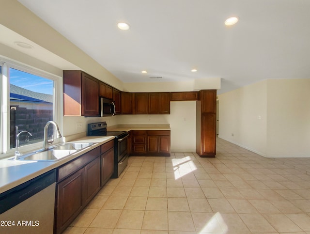 kitchen featuring sink, appliances with stainless steel finishes, and light tile patterned floors